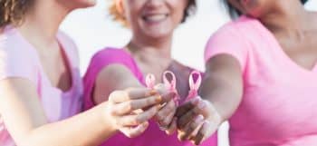 woman holding breast cancer awareness signs