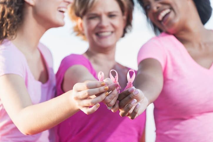 woman holding breast cancer awareness signs