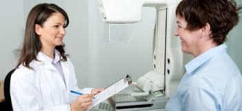 woman talking to radiologist before mammogram