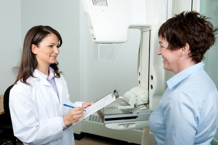 woman talking to radiologist before mammogram