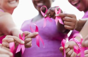 Group of women in pink, breast cancer awareness ribbons