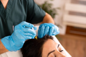 Doctor applies a Platelet Rich Plasma (PRP)Therapy Injection for Hair Rejuvenation into Scalp